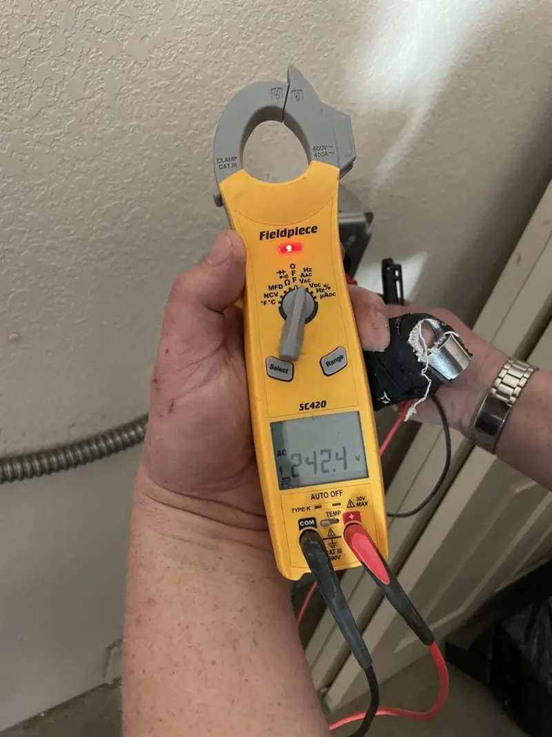 Voltage testing with clamp meter during Circuit Breaker Repair in Village of Oak Creek (Big Park)